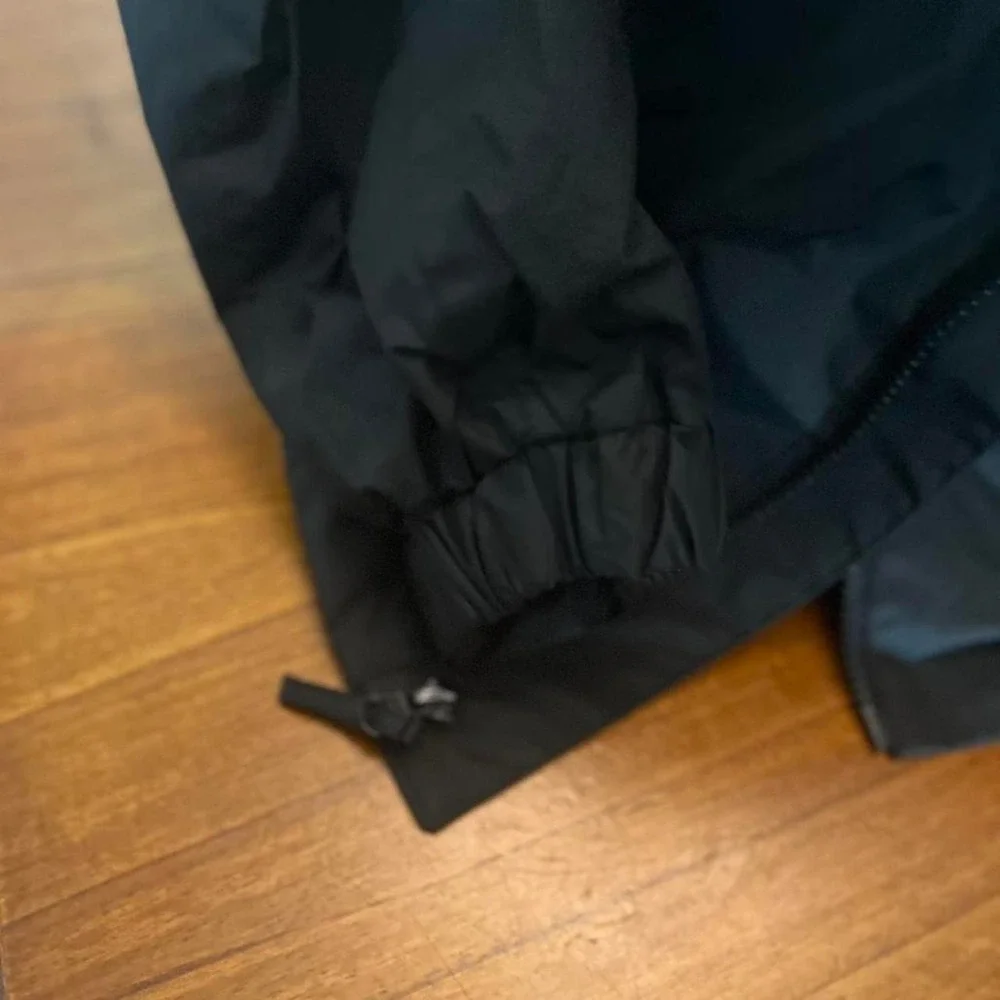Black and grey waterproof jacket with removable hood